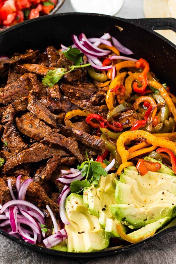carne asada steak meat with vegetables in a pan