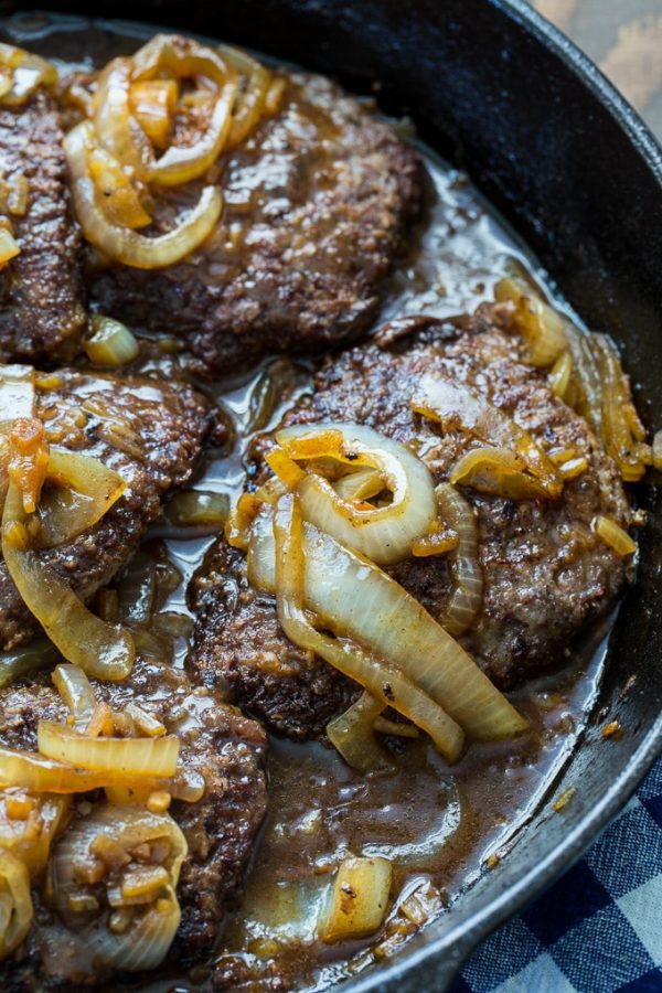 cubed steak in a pan with carmelized onions