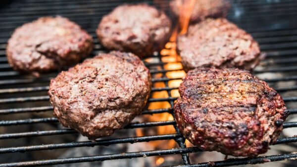 juicy grass fed hamburgers on a barbecue grill