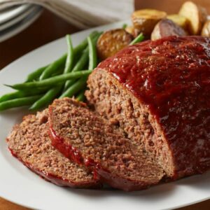 Beautiful meat loaf with green beens around it