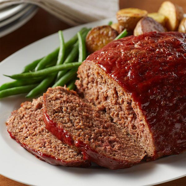 Beautiful meat loaf with green beens around it