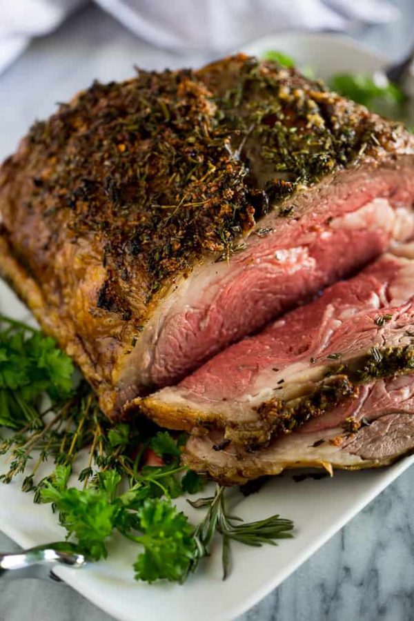 Freshly cooked prime rib that has been sliced with seasoning on top