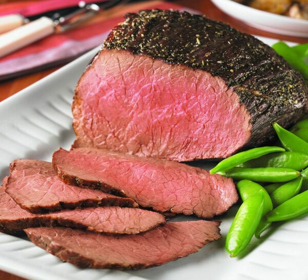 perfectly grilled rump roast that has been sliced on a plate