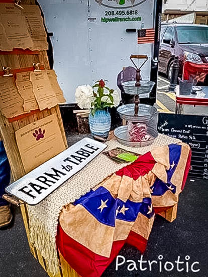 Hipwell ranch display at a farmers market with a table and a farm to table sign